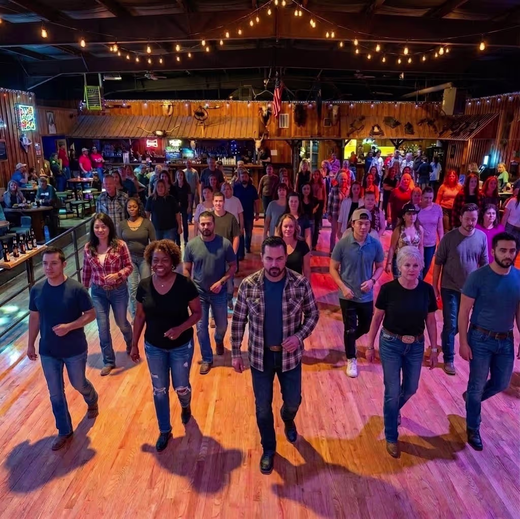 Indoor country bar line dancing class with a large group on a wooden dance floor